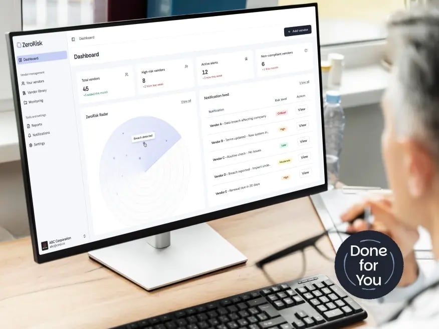 Person looking at a computer with the compliance application screen displayed.